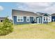 View of the rear exterior with blue siding and a sliding glass door to access the yard at 1803 Jackson St, Fortville, IN 46040