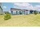 Spacious backyard with blue vinyl siding home and patio area for outdoor enjoyment at 1803 Jackson St, Fortville, IN 46040