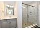 Bathroom featuring vanity with storage, drawers, white countertop, a sink, a mirror, and a shower at 1803 Jackson St, Fortville, IN 46040