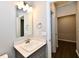 This bright bathroom has a sink with stylish faucet and an open door to a hallway at 1803 Jackson St, Fortville, IN 46040