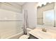 This bright bathroom has a white tiled shower, modern sink and a large mirror at 1803 Jackson St, Fortville, IN 46040