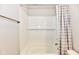 This bright bathroom has a white tiled shower and a gray and white shower curtain at 1803 Jackson St, Fortville, IN 46040