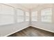 Bedroom featuring laminate floors and multiple windows at 1803 Jackson St, Fortville, IN 46040