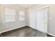 Bedroom featuring laminate floors, a sliding glass door, and multiple windows at 1803 Jackson St, Fortville, IN 46040