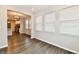 Bright dining area with hardwood floors and multiple windows, adjoined to the kitchen at 1803 Jackson St, Fortville, IN 46040