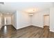 Open dining area with wood floors and neutral paint opens into the living room at 1803 Jackson St, Fortville, IN 46040