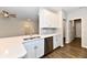 Bright kitchen features white cabinets, stainless steel appliances, quartz countertop and view to the living room at 1803 Jackson St, Fortville, IN 46040