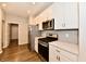 Close up of the white kitchen cabinets, stainless steel appliances, and tile backsplash at 1803 Jackson St, Fortville, IN 46040
