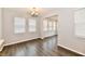 This open living room has lots of natural light, dark wood flooring and a modern chandelier at 1803 Jackson St, Fortville, IN 46040