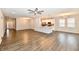 Spacious open-concept living space with modern floors, a ceiling fan, and bright kitchen in the background at 1803 Jackson St, Fortville, IN 46040