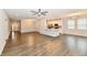 Spacious open-concept living space with modern floors, a ceiling fan, and bright kitchen in the background at 1803 Jackson St, Fortville, IN 46040