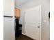 The utility room features a water softener, cabinet, and a door for organized home maintenance at 1803 Jackson St, Fortville, IN 46040