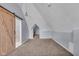 Attic space with dormers, carpet, and a decorative light fixture at 1854 Applegate St, Indianapolis, IN 46203