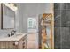 Modern bathroom featuring a vanity and decorative shelving with a view to the kitchen at 1854 Applegate St, Indianapolis, IN 46203