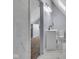 Elegant bathroom showcasing a white vanity, toilet, and luxurious marble floors with an open view to attic space at 1854 Applegate St, Indianapolis, IN 46203