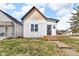 This home features vertical siding, cedar shake roof accent, and a compact front porch at 1854 Applegate St, Indianapolis, IN 46203