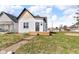 This home features vertical siding, cedar shake roof accent, and a compact front porch at 1854 Applegate St, Indianapolis, IN 46203