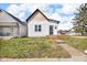 Charming home featuring vertical siding, cedar shake roof accent, and a compact front porch at 1854 Applegate St, Indianapolis, IN 46203