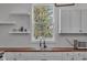 Kitchen sink area features white cabinets and a garden window at 1854 Applegate St, Indianapolis, IN 46203