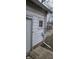 Exterior view of a white home featuring a window, door, and electrical components at 2028 George St, Anderson, IN 46016