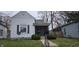Charming home featuring a quaint screened-in front porch and tidy landscaping at 2028 George St, Anderson, IN 46016