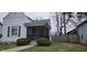 Charming home featuring a quaint screened-in front porch and tidy landscaping at 2028 George St, Anderson, IN 46016