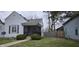Charming home featuring a quaint screened-in front porch and tidy landscaping at 2028 George St, Anderson, IN 46016