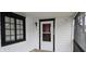 Cozy covered porch with wooden deck and black framed windows at 2028 George St, Anderson, IN 46016