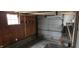 Spacious garage with an overhead door, a window for natural light, and wooden workbench area at 2028 George St, Anderson, IN 46016