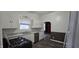 Bright kitchen with white cabinets, stainless steel appliances and view to another room at 2028 George St, Anderson, IN 46016