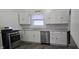 Well-lit kitchen featuring white cabinetry, stainless steel appliances, and modern finishes at 2028 George St, Anderson, IN 46016