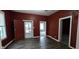 Inviting living room featuring wood floors and a charming front door at 2028 George St, Anderson, IN 46016