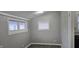 A gray room featuring two windows and vinyl floors offering brightness and functional space at 2028 George St, Anderson, IN 46016