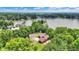 An aerial view showcasing lakefront living with mature trees and lush greenery surrounding the property at 22 Point Ln, Arcadia, IN 46030