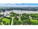 An aerial view showcases lakefront living with mature trees and lush greenery surrounding the property at 22 Point Ln, Arcadia, IN 46030