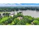 An aerial view showcases lakefront living with mature trees and lush greenery surrounding the property at 22 Point Ln, Arcadia, IN 46030