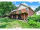 A two story brick home featuring a wooden deck on the second floor, a walkout basement, and green lawn at 22 Point Ln, Arcadia, IN 46030