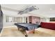 Spacious basement with a pool table, brick fireplace, light hardwood floors and partial bar area at 22 Point Ln, Arcadia, IN 46030