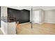 Basement featuring wood flooring, black accent wall, and a corner bar area at 22 Point Ln, Arcadia, IN 46030