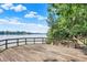 Wooden deck overlooking calm lake, lush trees create a peaceful retreat at 22 Point Ln, Arcadia, IN 46030