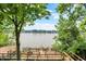 Multi-level wooden deck providing stunning lake views, nestled amidst trees and landscaping at 22 Point Ln, Arcadia, IN 46030