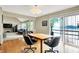 Dining area adjacent to living room with wood floors and sliding doors to lake at 22 Point Ln, Arcadia, IN 46030