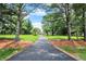 Long driveway leading to a home surrounded by trees and lush green lawn at 22 Point Ln, Arcadia, IN 46030