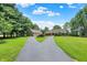 Home with a circular driveway, mature trees, and well manicured landscaping at 22 Point Ln, Arcadia, IN 46030