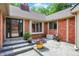 Charming brick porch featuring a modern front door, gray pavers, and colorful flower pots at 22 Point Ln, Arcadia, IN 46030