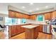 Bright kitchen with wood cabinetry, island, and eat-in area with access to the outdoors at 22 Point Ln, Arcadia, IN 46030