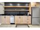 Contemporary kitchenette with black countertops, floating shelves, and stainless steel appliances at 22 Point Ln, Arcadia, IN 46030