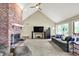 Bright living room featuring a vaulted ceiling, fireplace, and ample natural light through large windows at 22 Point Ln, Arcadia, IN 46030