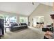 Large living room with lake views, featuring a cozy sofa and sliding glass doors at 22 Point Ln, Arcadia, IN 46030