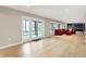 Large living room with wood floors, a red sectional sofa, and expansive sliding glass doors to the outside at 22 Point Ln, Arcadia, IN 46030